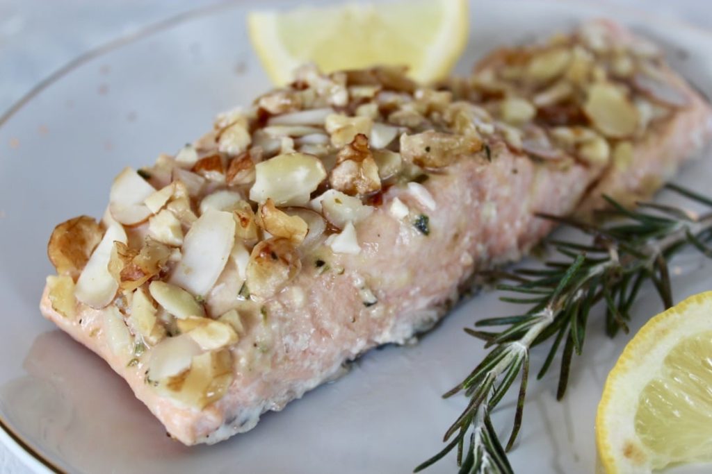 This simple nut crusted salmon takes just 5 minutes to whip up and is on the table in under 30 minutes! The honey mustard glaze topped with nuts is the perfect combination of sweet and savory