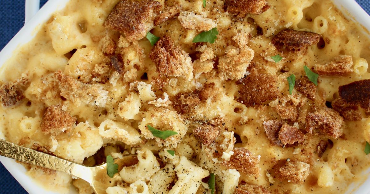 Sharp cheddar, muenster, and asiago makes for an indulgent, three cheese Homemade Breadcrumb Baked Mac and Cheese. Some simple healthy recipe swaps help reduce the fat, maintain the protein and increase the fiber content of this classic recipe.