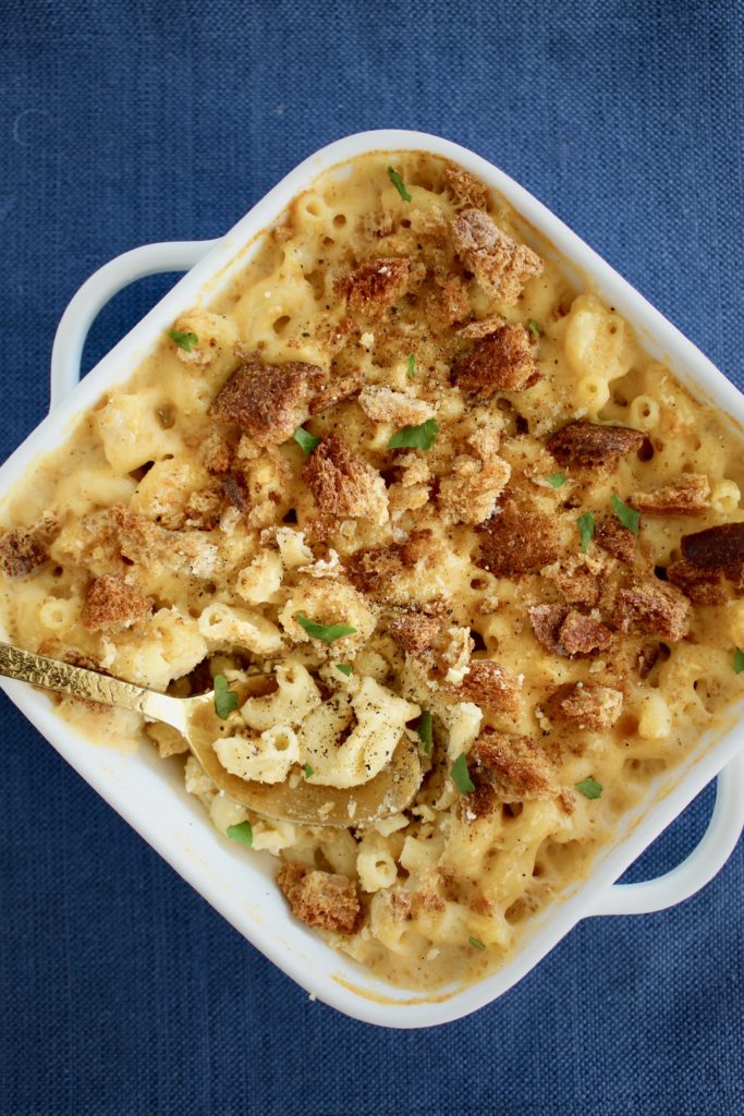 Sharp cheddar, muenster, and asiago makes for an indulgent, three cheese Homemade Breadcrumb Baked Mac and Cheese. Some simple healthy recipe swaps help reduce the fat, maintain the protein and increase the fiber content of this classic recipe.