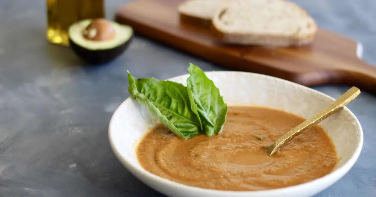 This homemade Tomato Basil Soup is juicy, flavorful, and simple to blend up. The perfect soup recipe to enjoy with seasonal or canned tomatoes! Serve with avocados, parmesan cheese, and whole grain bread.