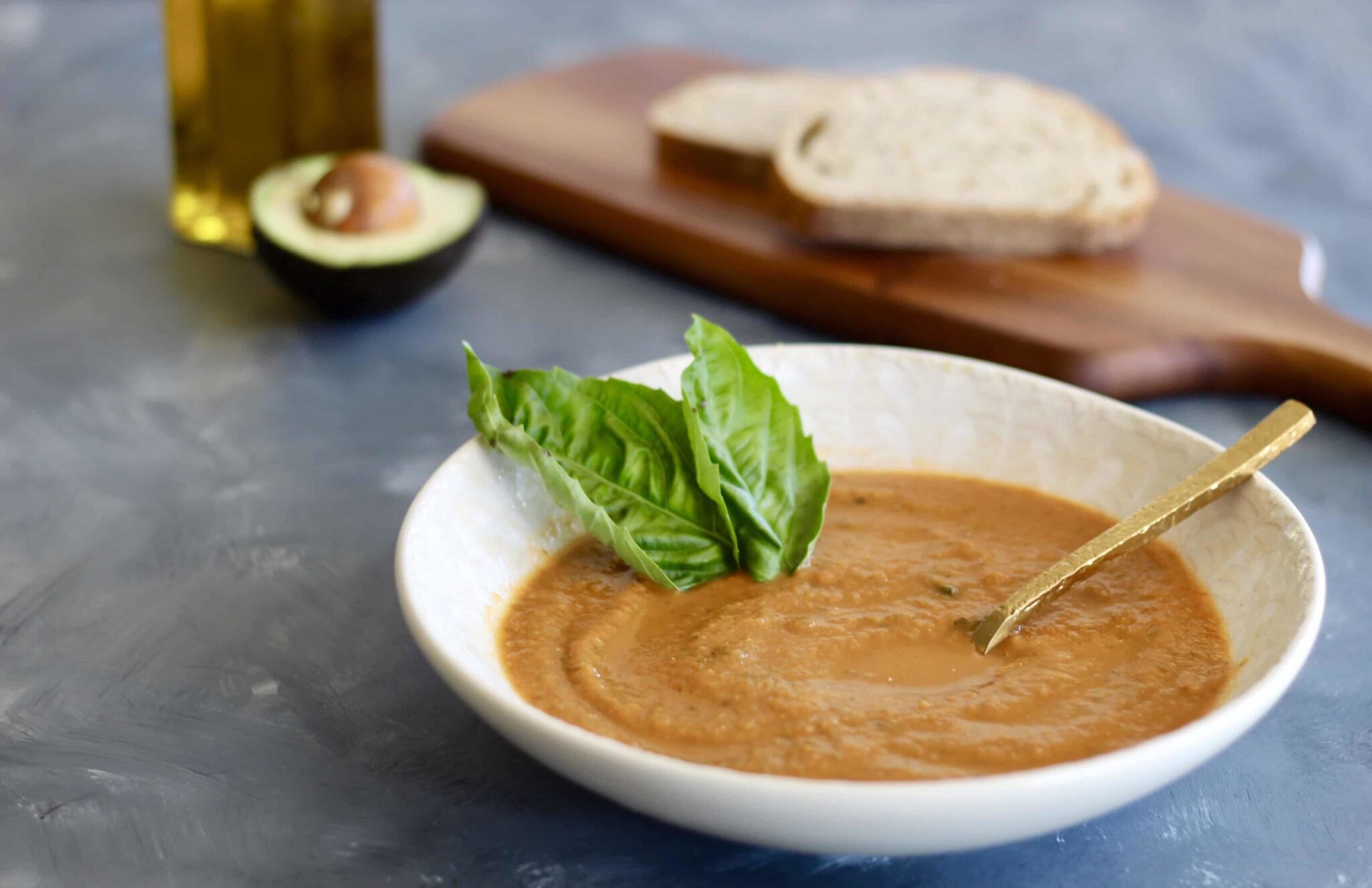 This homemade Tomato Basil Soup is juicy, flavorful, and simple to blend up. The perfect soup recipe to enjoy with seasonal or canned tomatoes! Serve with avocados, parmesan cheese, and whole grain bread.
