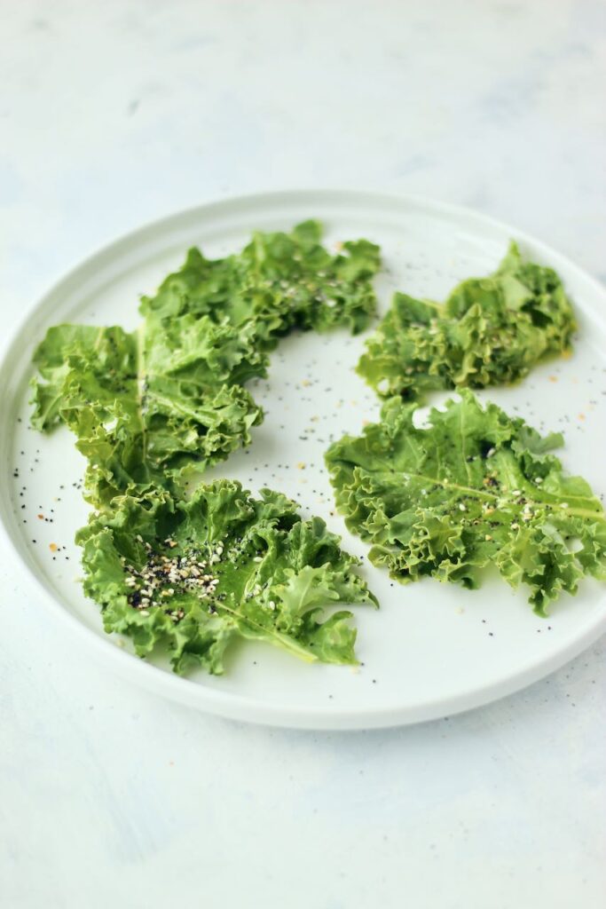 Kale chips on plate with seasonings