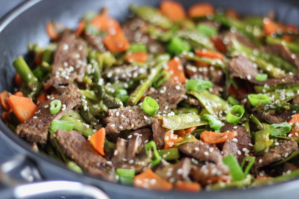 Incorporate seasonal ingredients like carrots, peas, and asparagus into this super quick Vegetable and Flank Steak Stir Fry. A perfect protein and veggie-packed recipe to whip up for your next meal. 