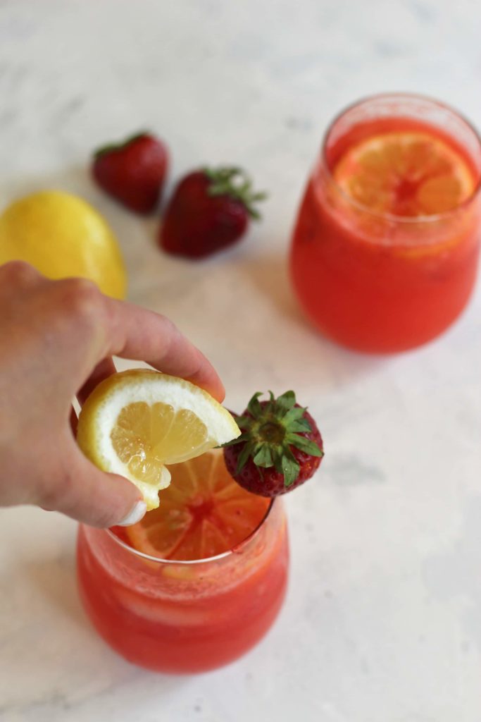 Squeezing lemon over drink