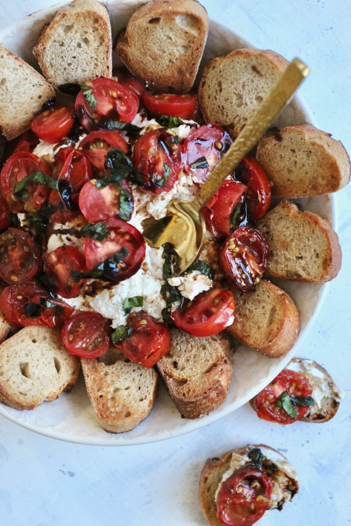 This creamy goat cheese caprese dip is a unique twist on a classic. Top it off with juicy tomatoes, fresh basil, and balsamic glaze to create a beautiful party-ready appetizer. #vegetarian #partyappetizer #healthyholiday #CheerfulChoices