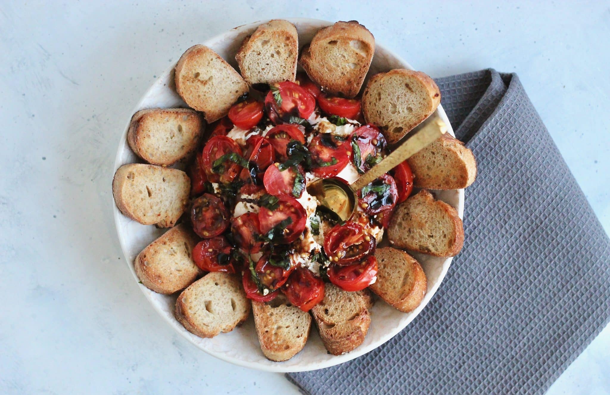 This creamy goat cheese caprese dip is a unique twist on a classic. Top it off with juicy tomatoes, fresh basil, and balsamic glaze to create a beautiful party-ready appetizer. #vegetarian #partyappetizer #healthyholiday #CheerfulChoices