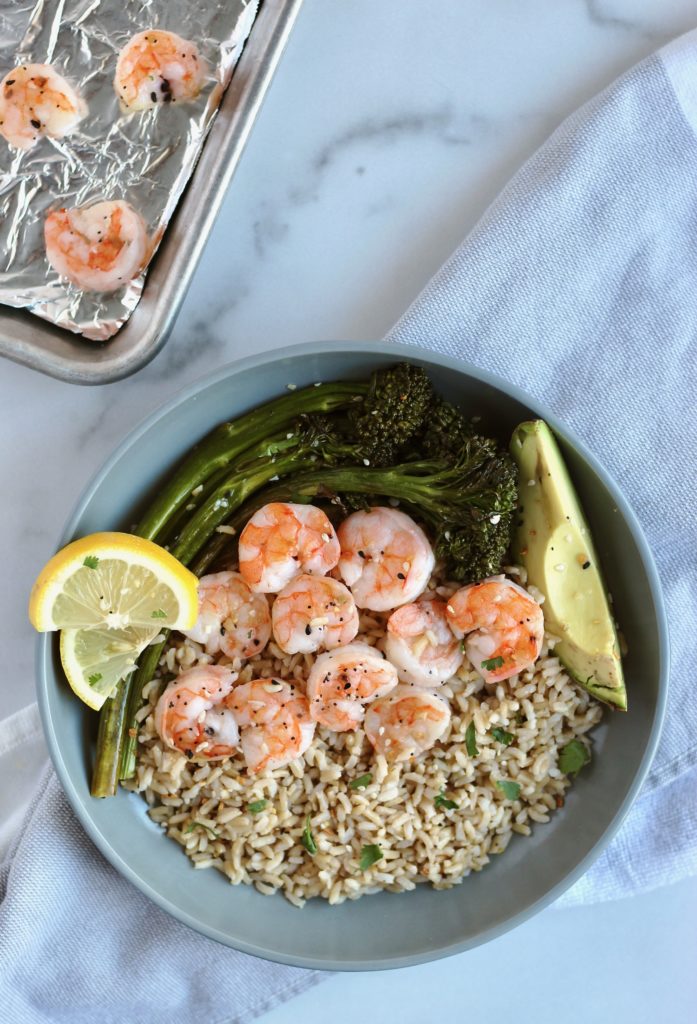 This easy 6 ingredient sheet pan dinner is on the table in less than 30 minutes. Serve with brown rice, avocado, and lemon wedges for a balanced meal. #shrimpdinner #sheetpanrecipe #6ingredients