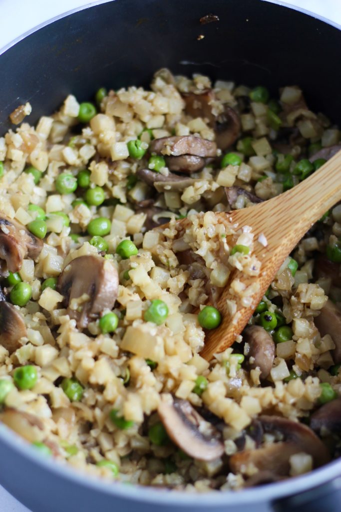 This creamy Mushroom Cauliflower Rice Risotto is a lighter alternative to regular risotto. Plus, it calls for just a few simple ingredients, and cooks up in 20 minutes flat. Naturally gluten-free and vegan option! #healthyrecipes #vegetables #cauliflowerrice #sidedish