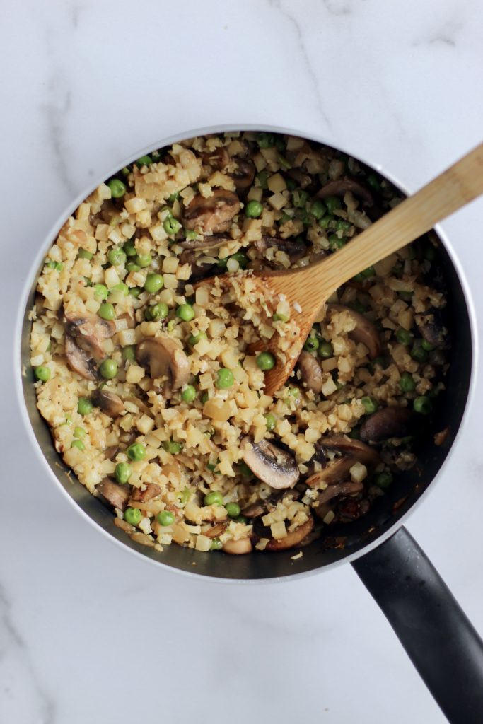 This creamy Mushroom Cauliflower Rice Risotto is a lighter alternative to regular risotto. Plus, it calls for just a few simple ingredients, and cooks up in 20 minutes flat. Naturally gluten-free and vegan option! #healthyrecipes #vegetables #cauliflowerrice #sidedish