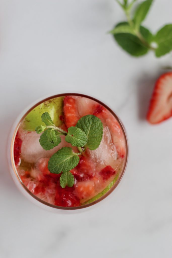 This light Strawberry Rosé Mojito is an elegant spin on the classic mint mojito. Unlike most sugary cocktails, this drink is only 100 calories and includes both sugar-free and low-sugar options. #healthydrinks #lowersugar #summercocktail #mojito 