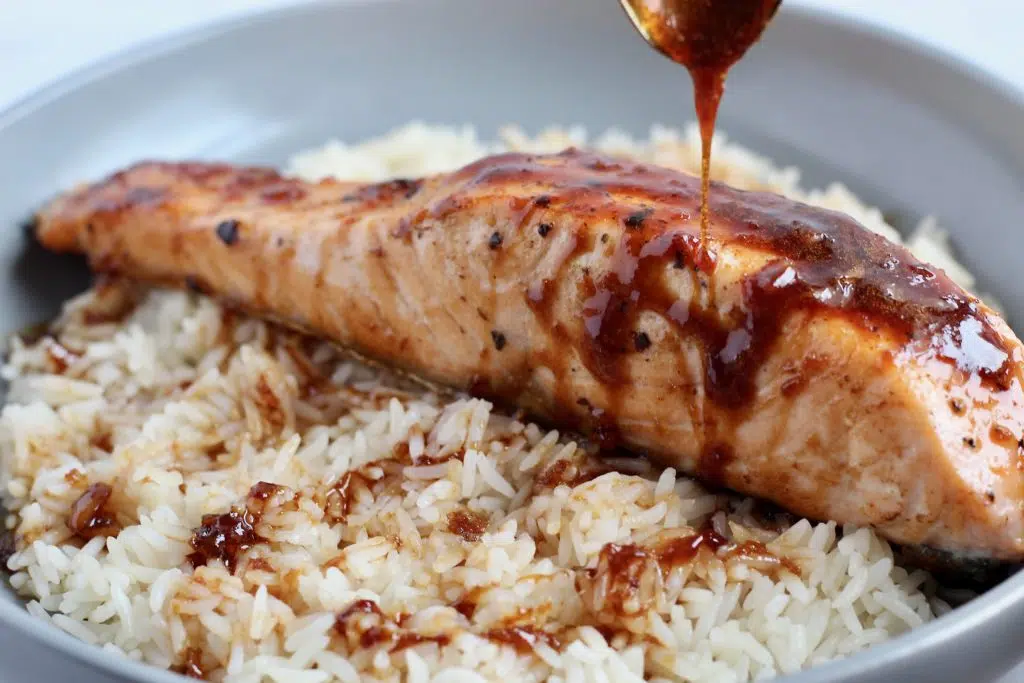 This Honey Soy Glazed Salmon is simple, yet so delicious. Fresh grilled or pan seared salmon fillets are topped with a flavorful glaze that you’ll want to eat on repeat. #SalmonRecipes #HoneySoy #Grilling #Umami