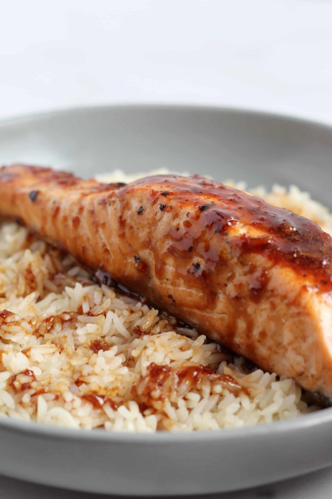 This Honey Soy Glazed Salmon is simple, yet so delicious. Fresh grilled or pan seared salmon fillets are topped with a flavorful glaze that you’ll want to eat on repeat. #SalmonRecipes #HoneySoy #Grilling #Umami
