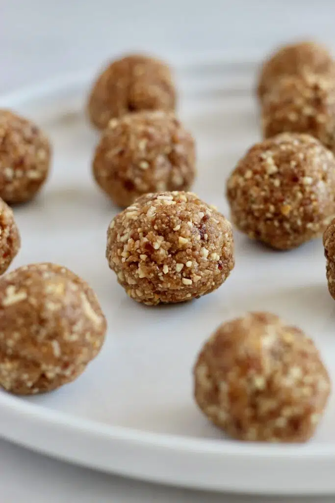 These Salted Caramel Energy Bites make the perfect energizing snack. They are packed with plant based protein to power your day. Plus, they are gluten-free, vegan, and have no added sugars! #VeganSnack #SaltedCaramel #EnergyBites #ProteinBites #Dates