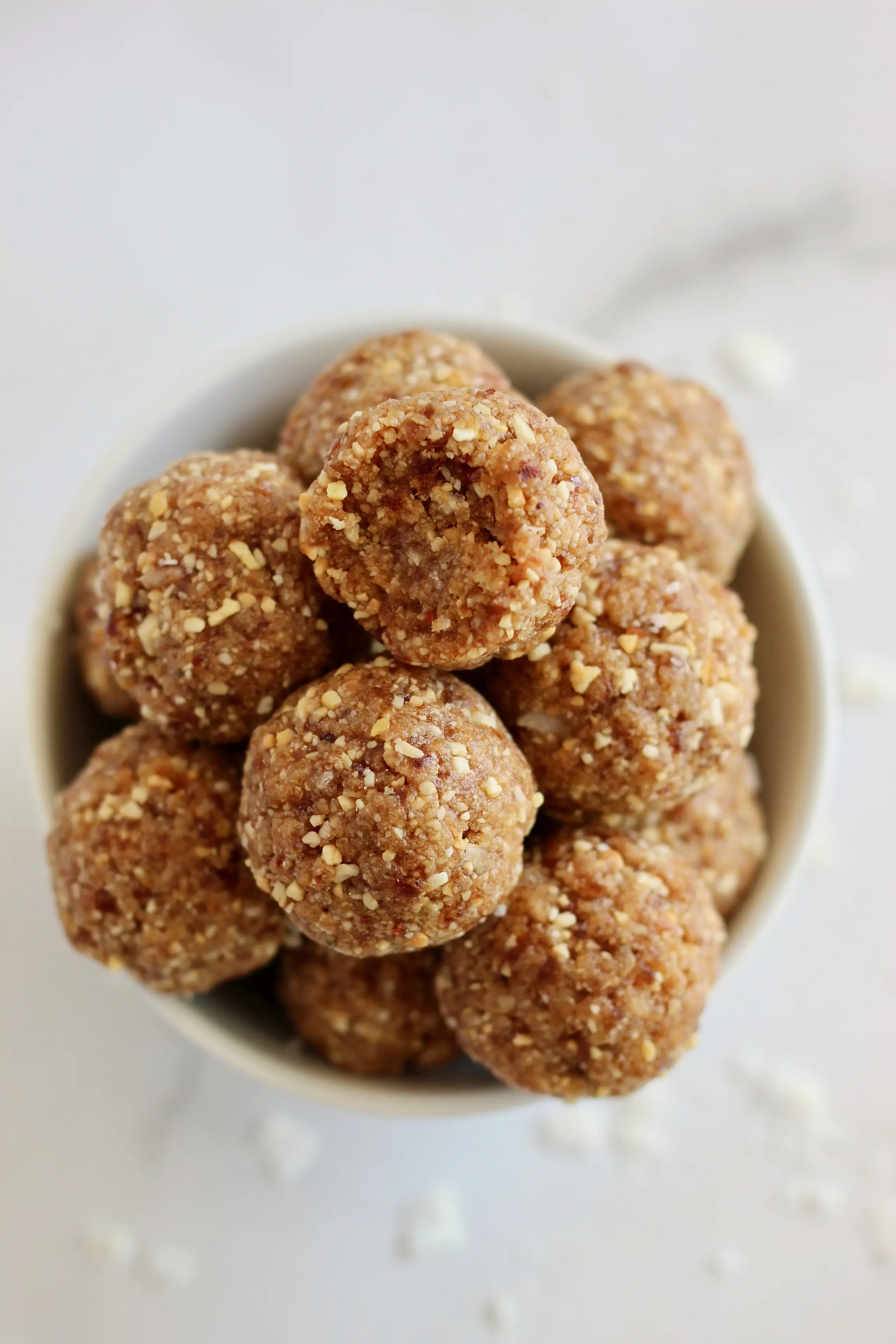 These Salted Caramel Energy Bites make the perfect energizing snack. They are packed with plant based protein to power your day. Plus, they are gluten-free, vegan, and have no added sugars! #VeganSnack #SaltedCaramel #EnergyBites #ProteinBites #Dates