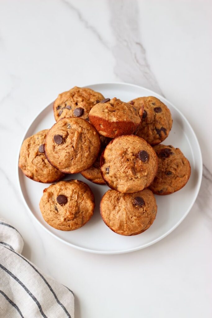 Protein banana muffins stacked on a white plate