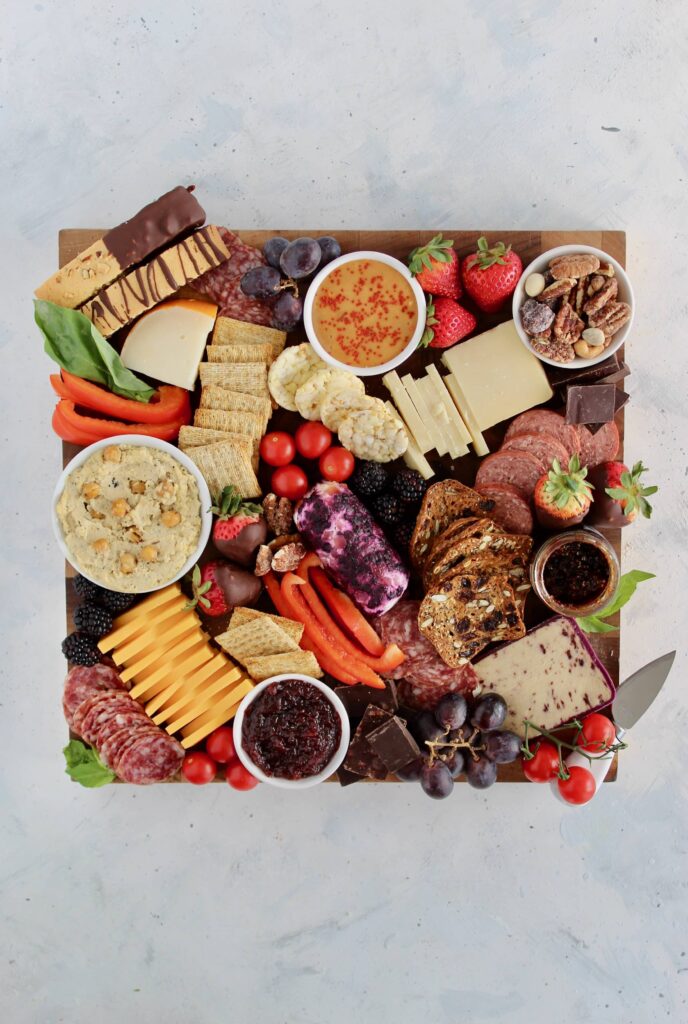 Learn how to make the perfect Valentine's Day Charcuterie Board for your loved ones. This customizable board is filled with all the good stuff like cheeses, meats, dips, fresh fruit, vegetables, and sweet treats.
