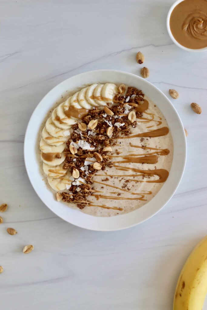 Peanut butter smoothie bowl on a white backdrop