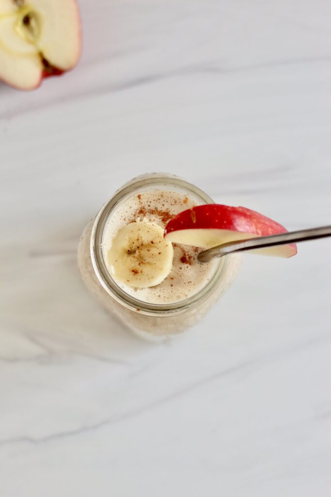 Smoothie garnished with banana and apple