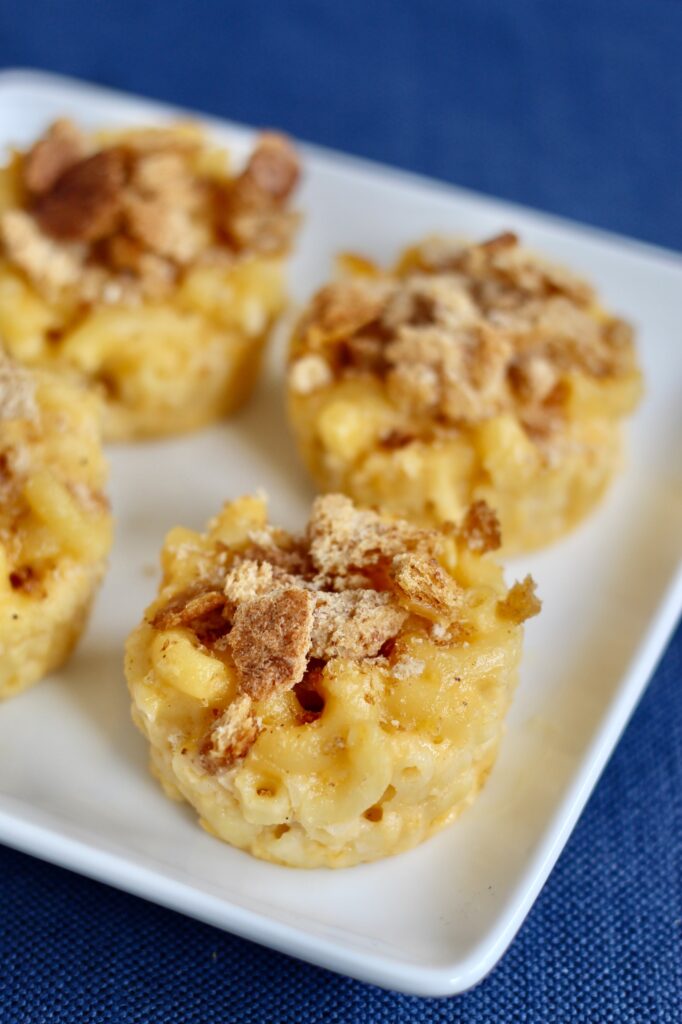 Close up of mac and cheese bites on blue backdrop