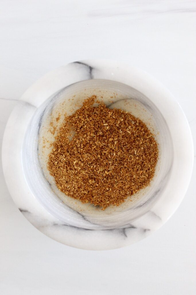 Ground cumin seeds in mortar and pestle