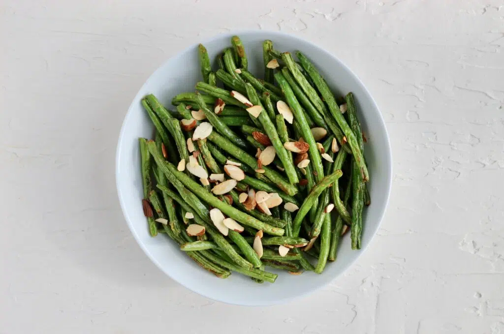 Green beans topped with sliced almonds