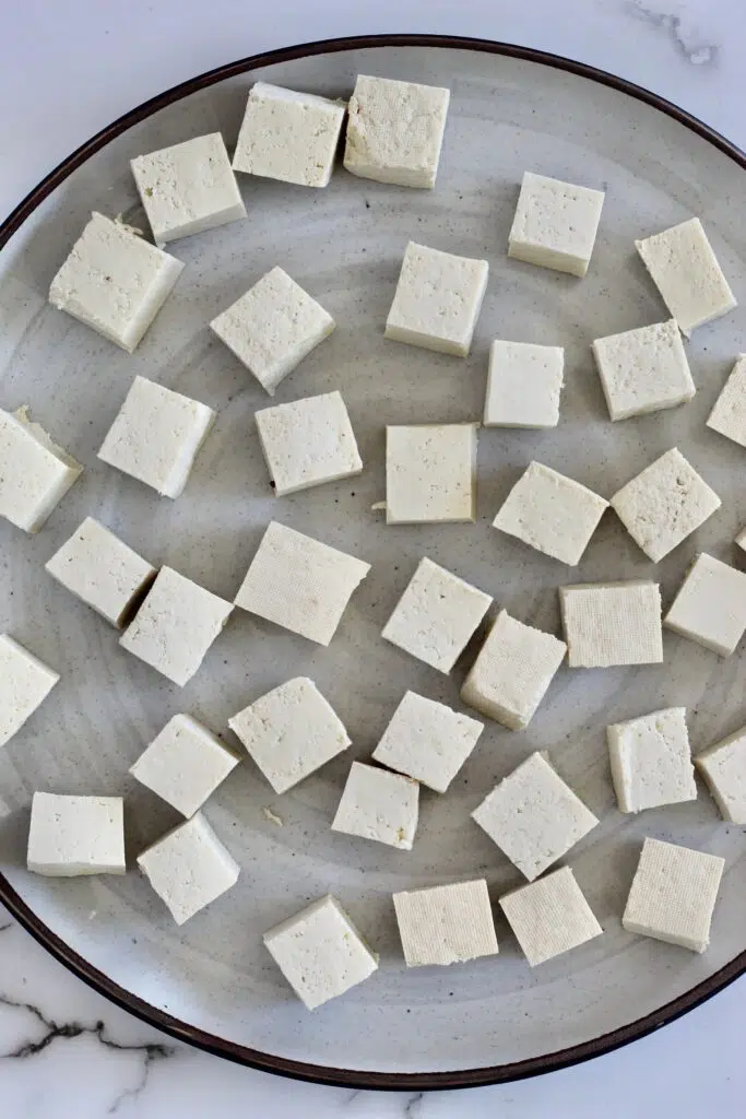 Cubed tofu on a white plate
