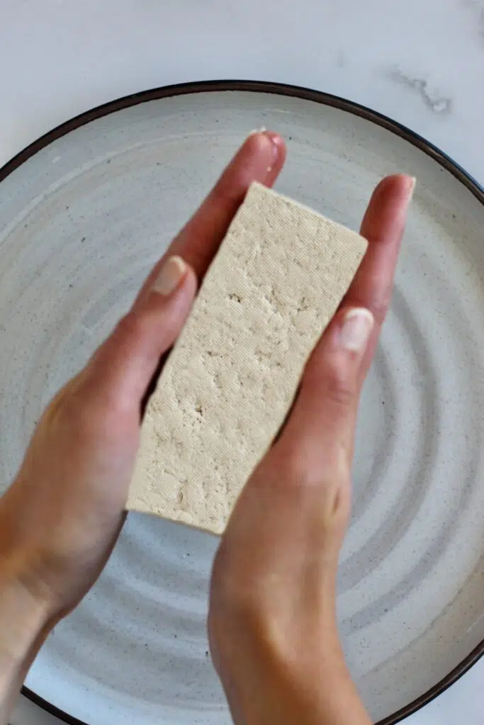 Pressing tofu by hand