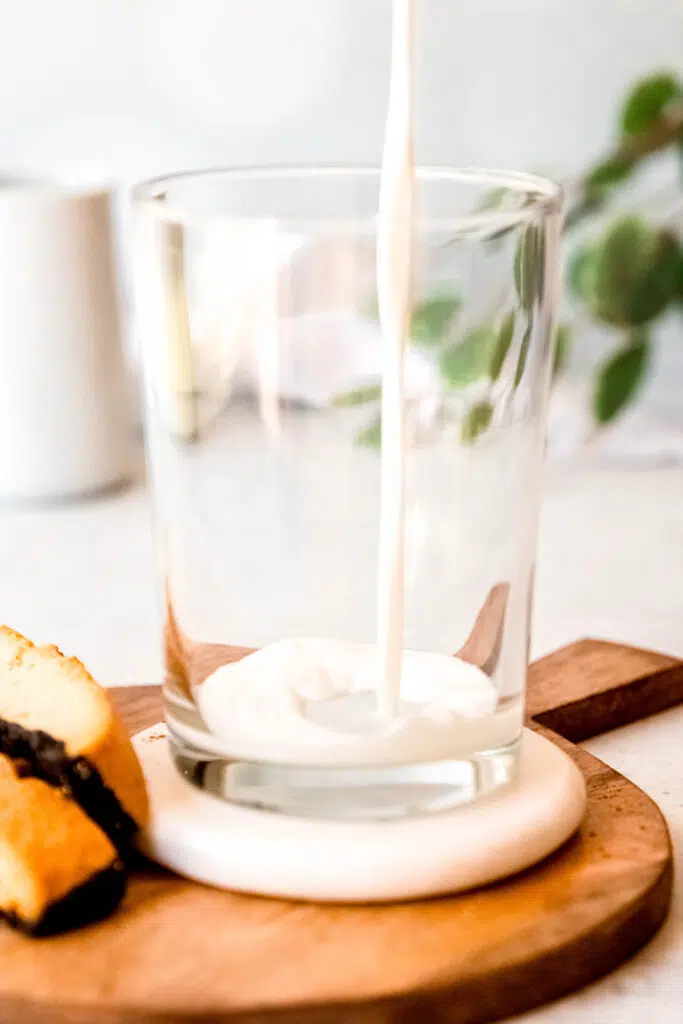 Pouring milk over protein coffee glass