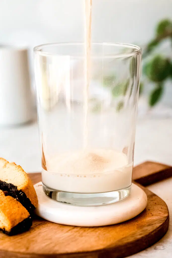 Pouring milk over protein coffee glass