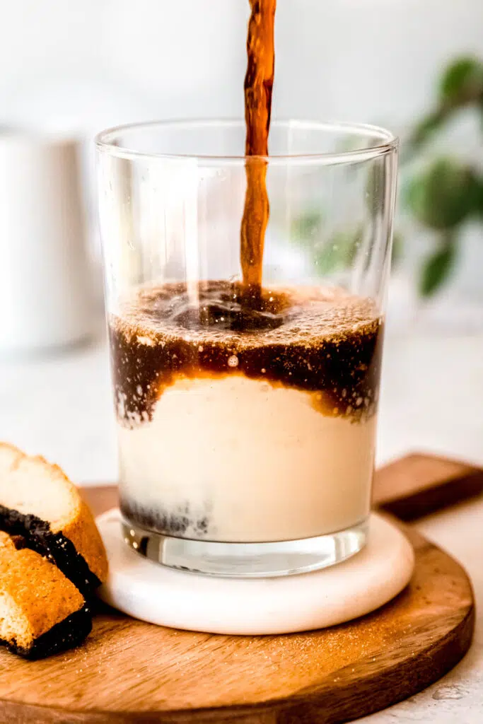 Pouring coffee over protein coffee glass