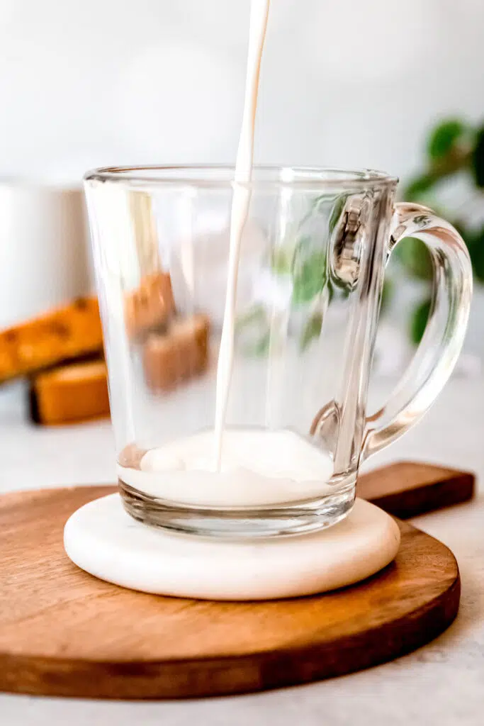 Pouring milk over protein coffee glass