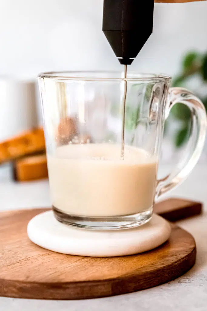 Pouring milk over protein coffee glass