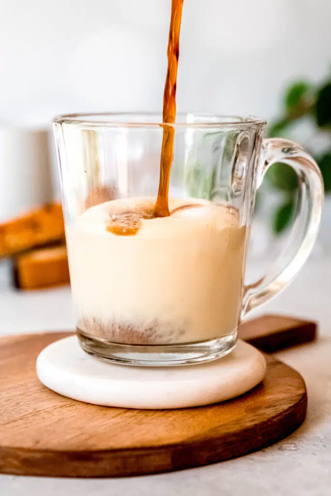 Pouring coffee over protein coffee glass