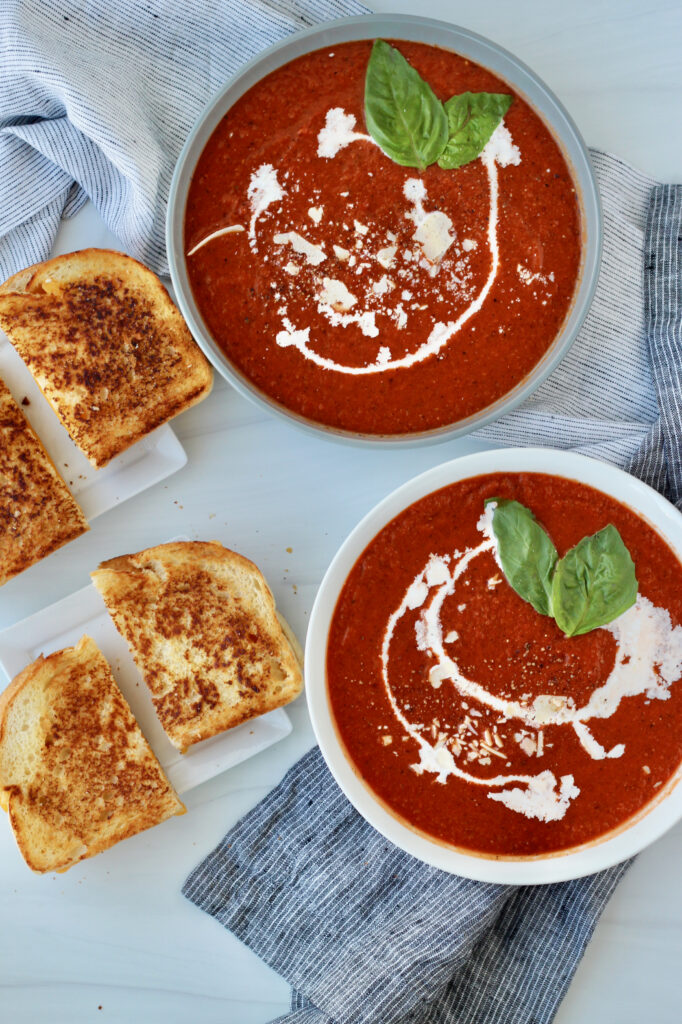 Grilled Cheese and Tomato Soup on white backdrop