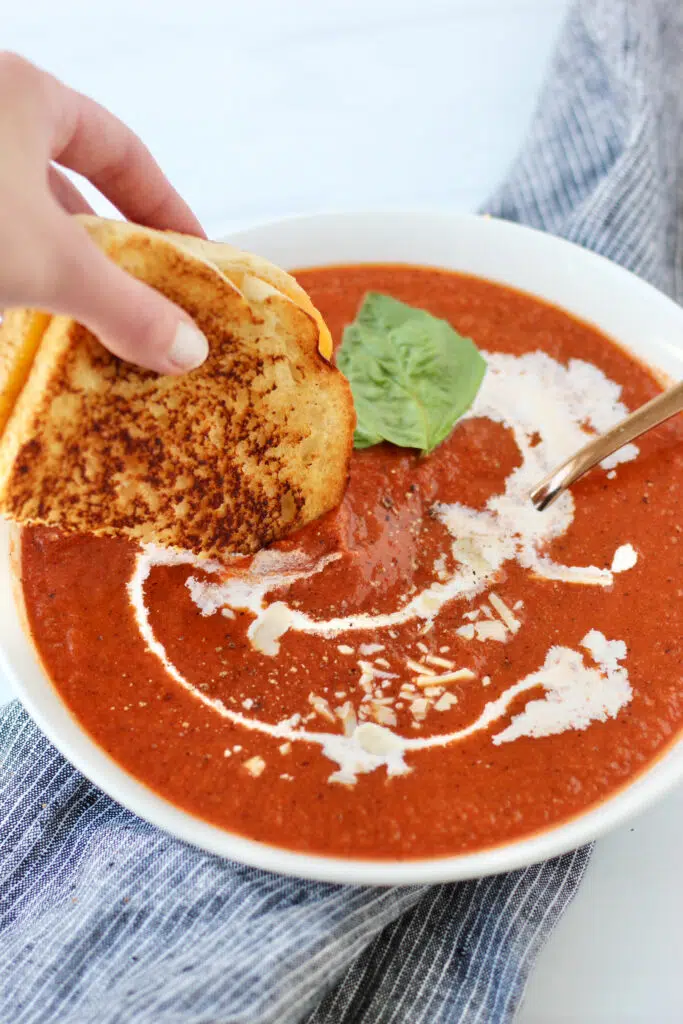 Dripping grilled cheese into creamy tomato soup