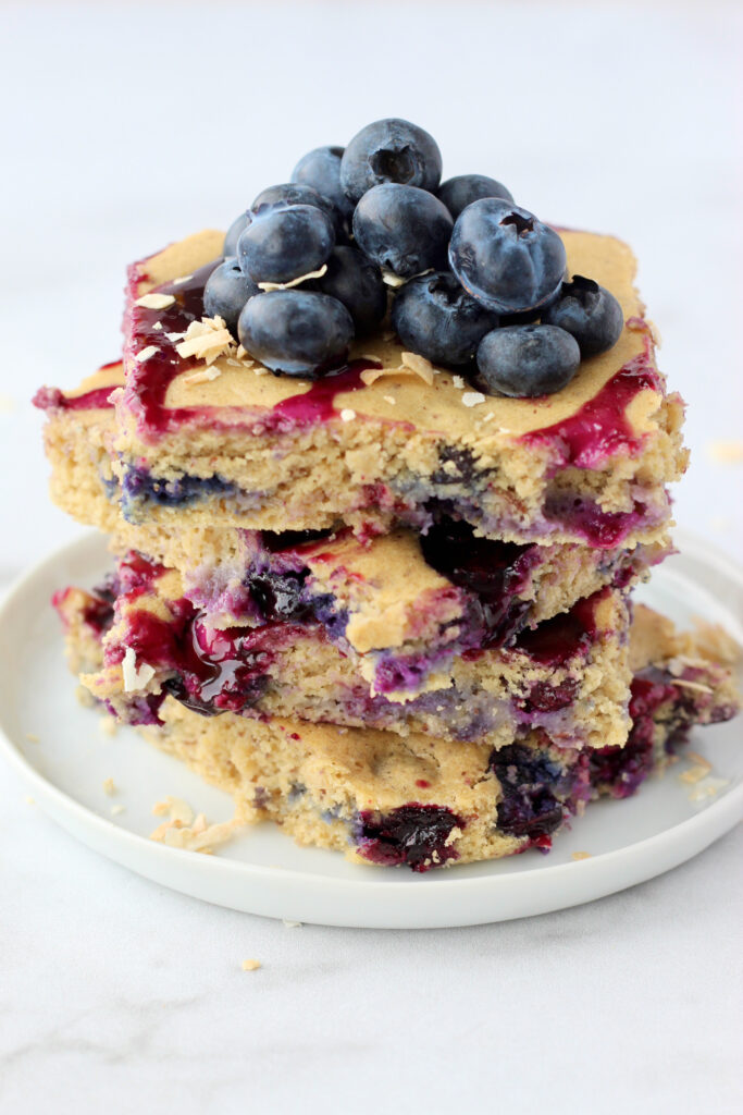 Stack of blueberry pancakes topped with fresh blueberries