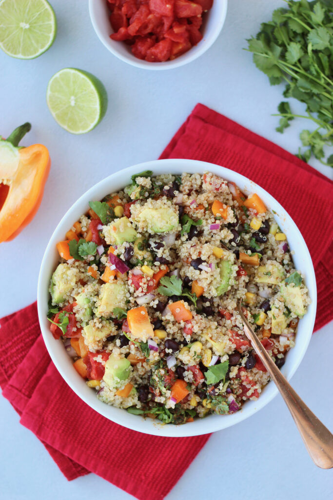 Colorful southwest quinoa salad topped with avocado
