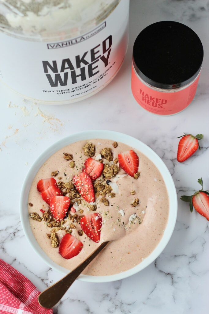 Pink smoothie bowl topped with strawberries
