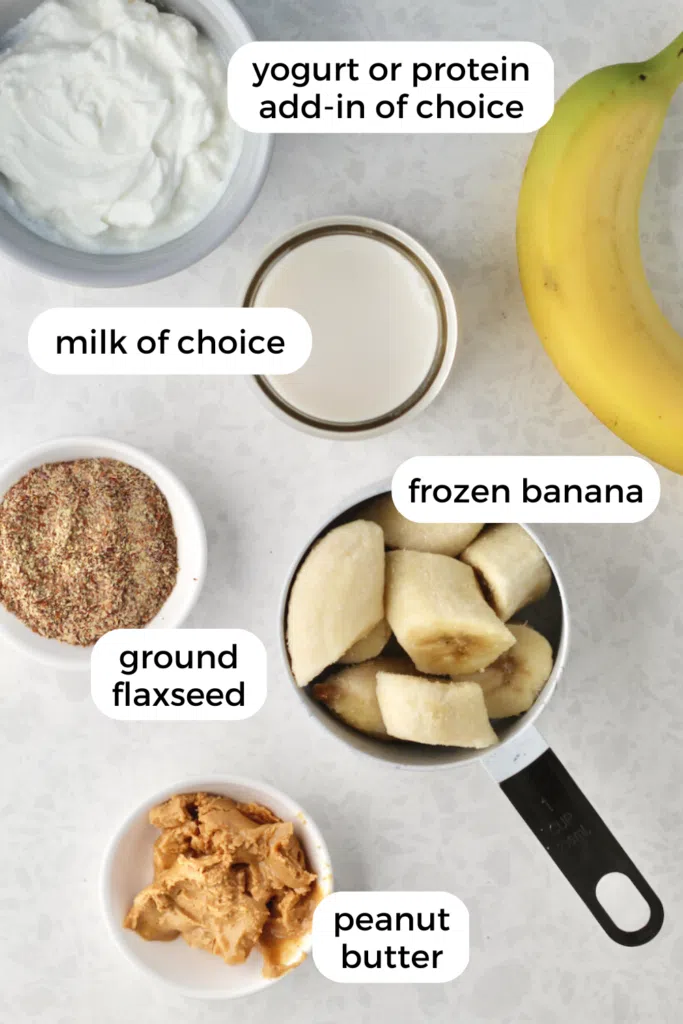 Ingredients used for smoothie including banana, ground flaxseed, peanut butter, and milk
