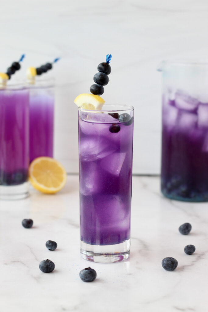 Refreshing purple lemonade infused with blueberries and butterfly pea powder