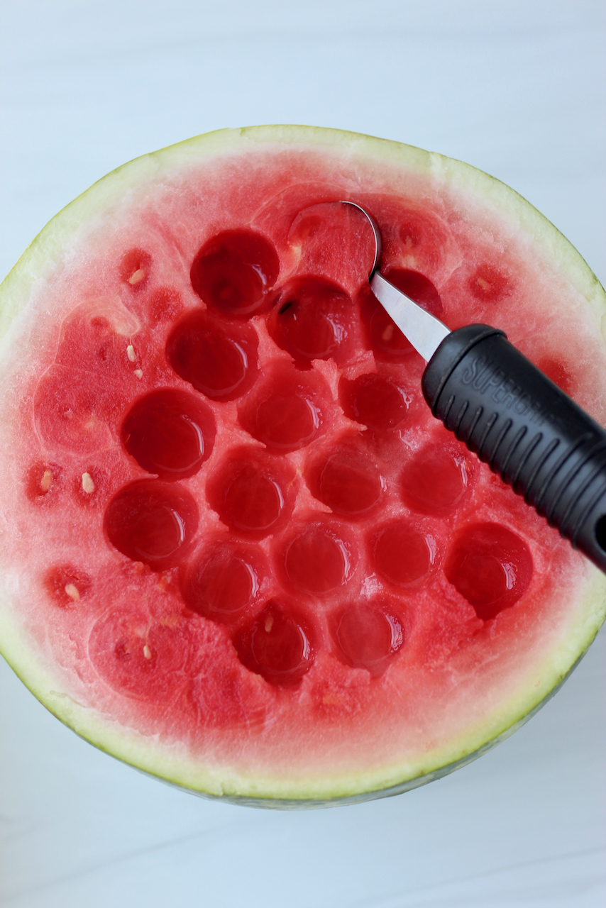 Scooping watermelon with melon baller
