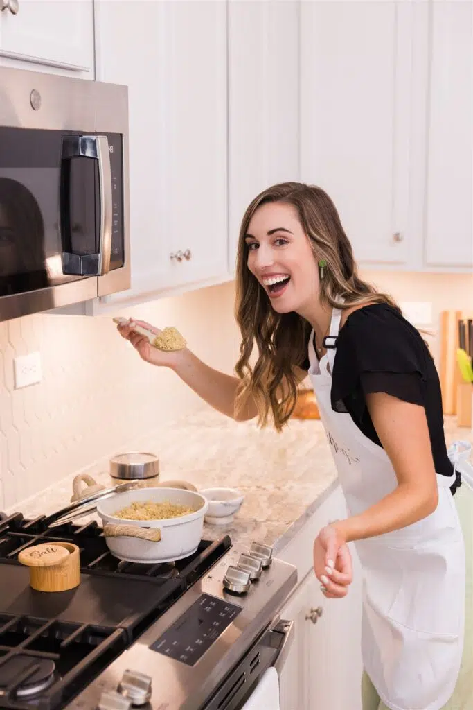 Happy in the kitchen taking bite of quinoa