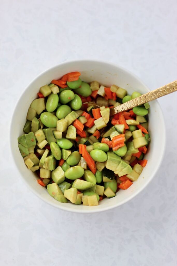Mixing veggies together in bowl