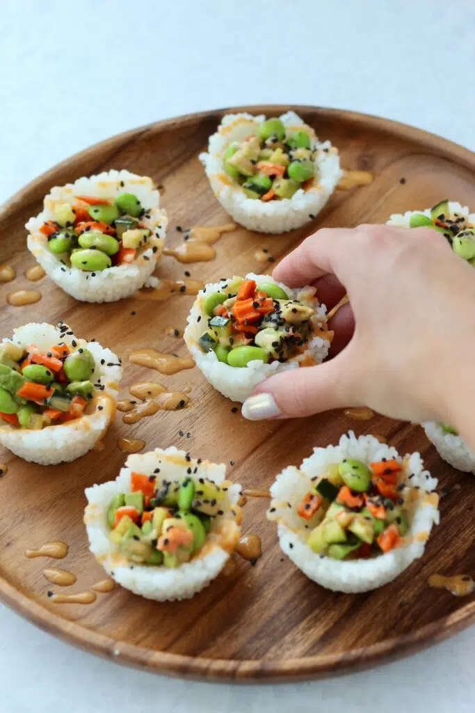 Grabbing sushi bite from tray