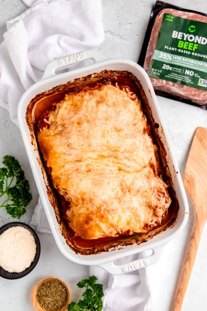 Italian Meatloaf topped with melted mozzarella cheese in a white baking dish