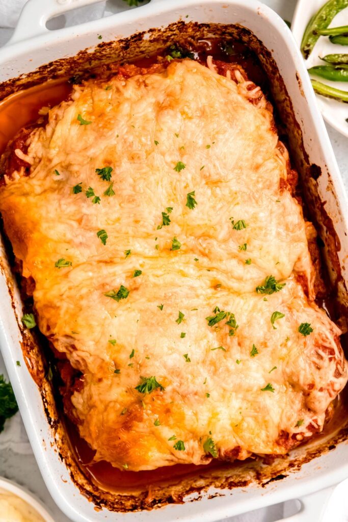 Baked Italian Meatloaf with a gooey cheese crust, ready to be sliced and served