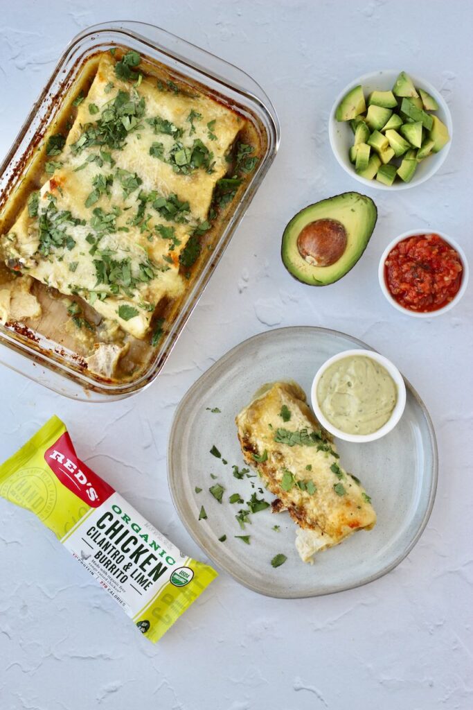 Freshly baked burrito casserole with avocado and salsa.