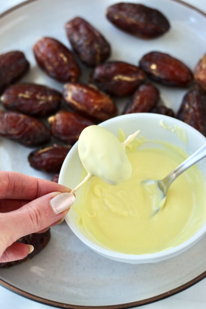 Dipping Medjool date in white chocolate