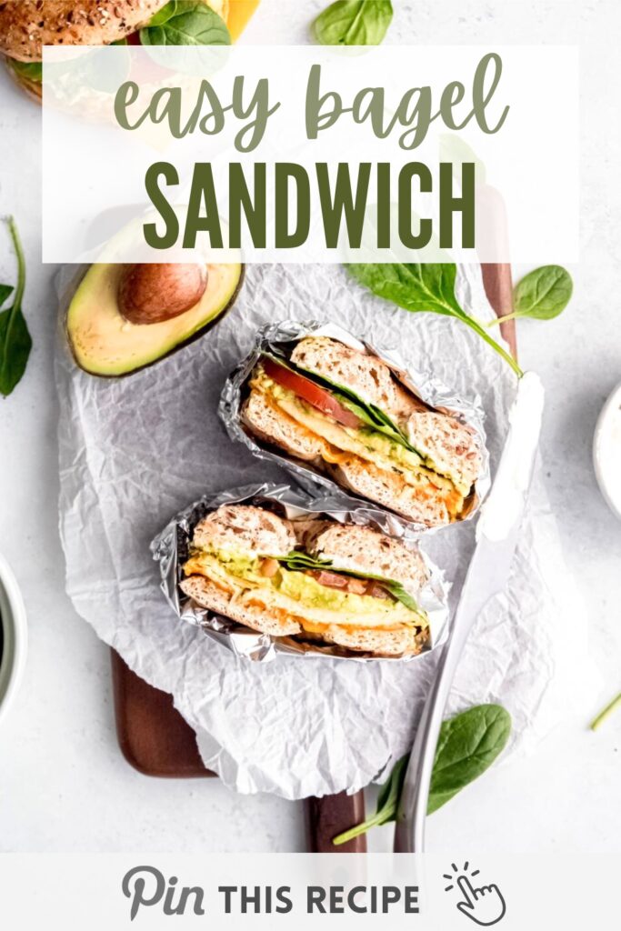 Easy bagel sandwich including egg patty, melted cheese, fresh tomato, avocado, and a handful of spinach.