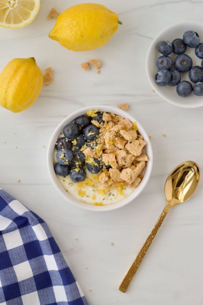 Lemon blueberry yogurt bowl with gold spoon
